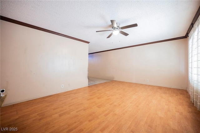 spare room with light wood-style floors, a textured ceiling, a ceiling fan, and ornamental molding