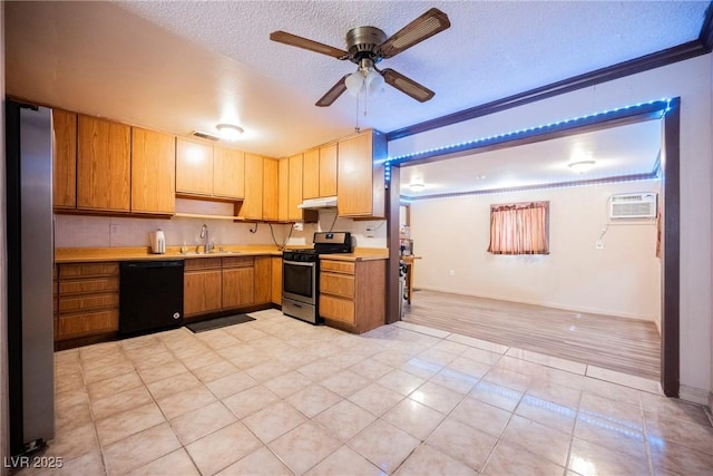 kitchen with a wall mounted air conditioner, stainless steel gas stove, light countertops, dishwasher, and a sink