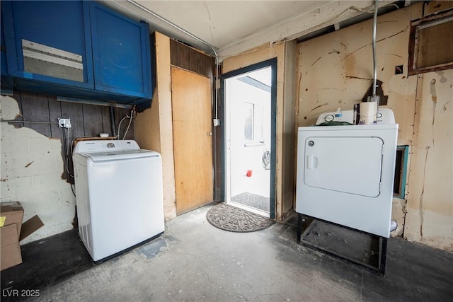 washroom with washing machine and clothes dryer and cabinet space