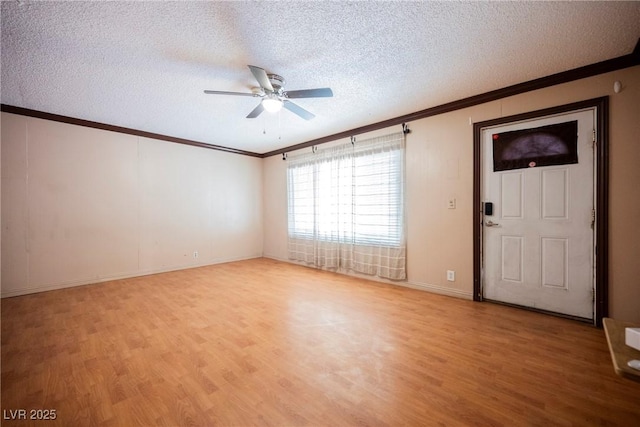 unfurnished room featuring ornamental molding, light wood-type flooring, baseboards, a textured ceiling, and ceiling fan