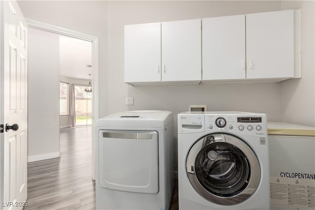 9604 Windom Point Ave, Las Vegas, NV 89129 - laundry area with cabinet space, independent washer and dryer, light wood-style floors, and baseboards