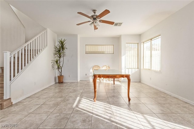 dining space with tile patterned floors, visible vents, stairway, and ceiling fan