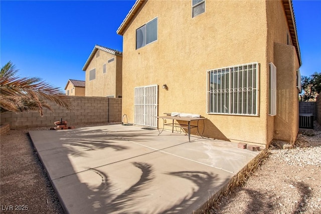rear view of property with cooling unit, a patio area, stucco siding, and fence