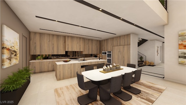 607 Grand Rim Dr, Henderson, NV 89012 - kitchen with modern cabinets, light countertops, a kitchen island with sink, brown cabinets, and stainless steel double oven