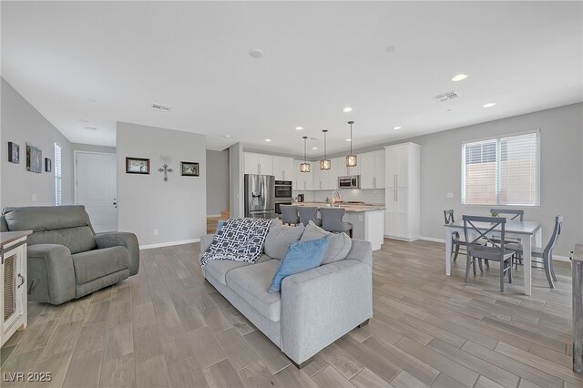 169 Volti Subito Way, Henderson, NV 89011 - living room with wood finish floors, baseboards, and recessed lighting