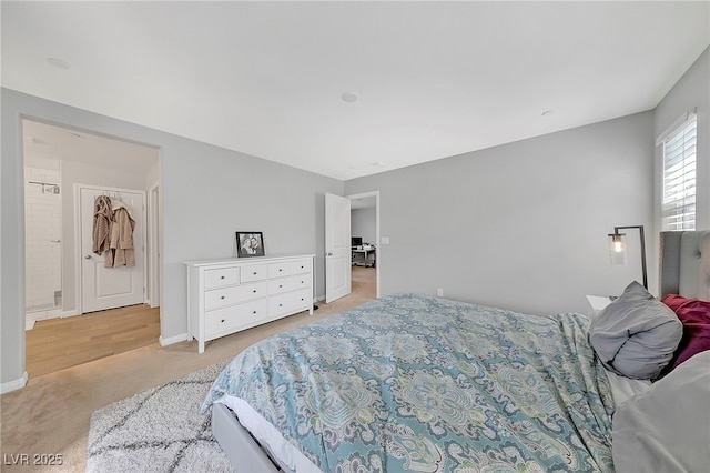 bedroom with light carpet and baseboards