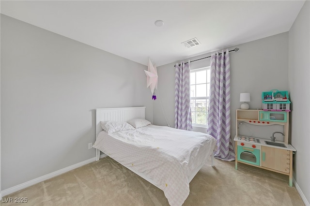 bedroom with light carpet, visible vents, and baseboards