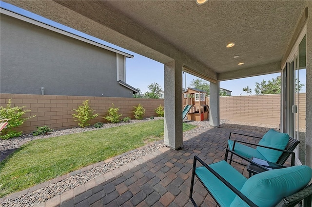view of patio / terrace with a fenced backyard and a playground