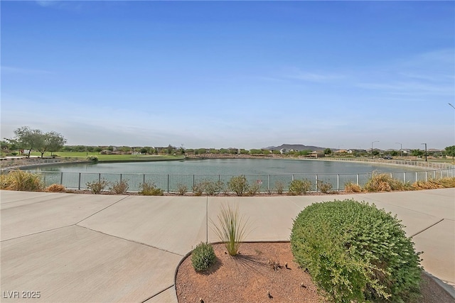 property view of water featuring fence
