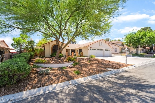 view of front of house with a garage, stucco siding, and driveway