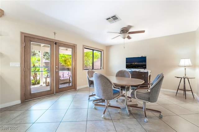 dining space with baseboards, french doors, a ceiling fan, and tile patterned floors