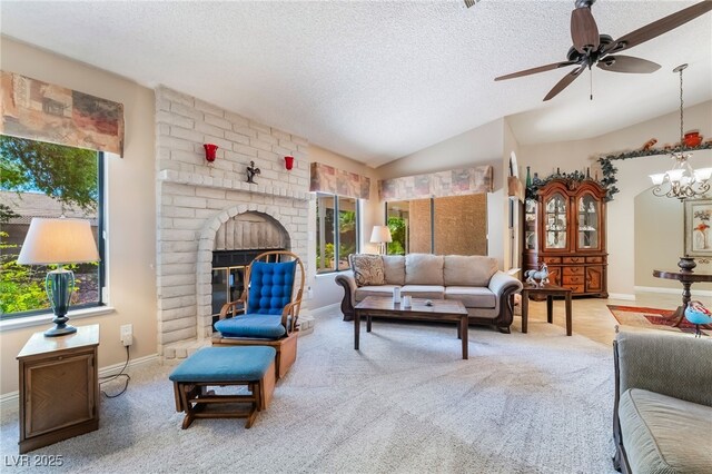 carpeted living area with a textured ceiling, ceiling fan, baseboards, vaulted ceiling, and a chandelier
