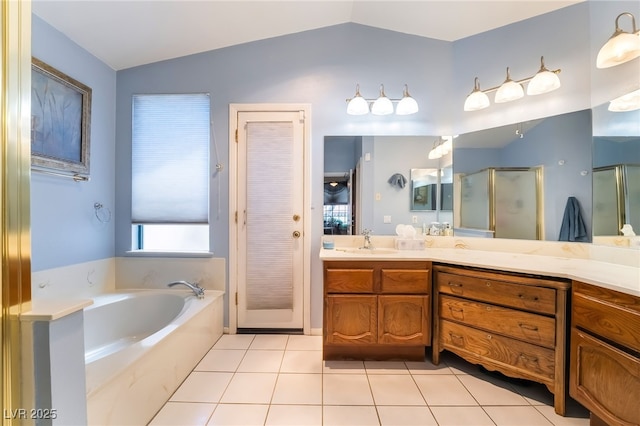 full bath featuring lofted ceiling, a shower stall, vanity, a garden tub, and tile patterned floors