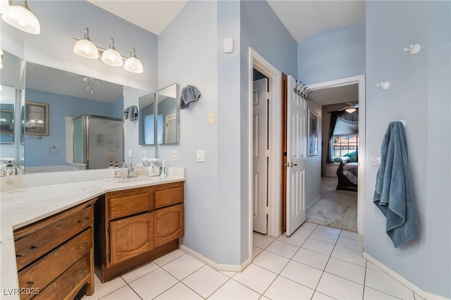 bathroom featuring a stall shower, tile patterned floors, ensuite bathroom, vanity, and baseboards