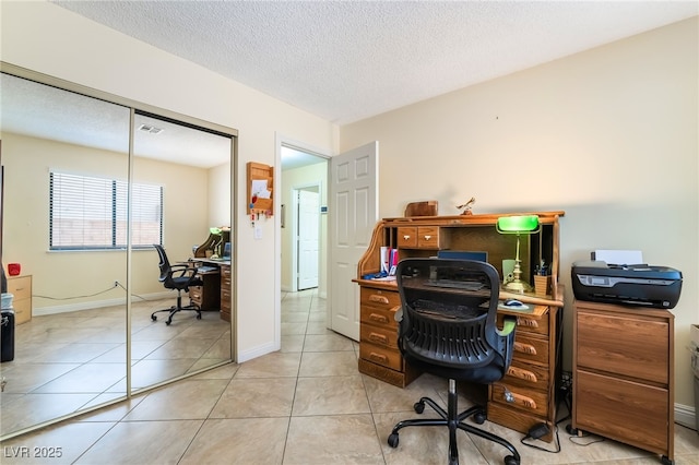 office area featuring light tile patterned floors and a textured ceiling