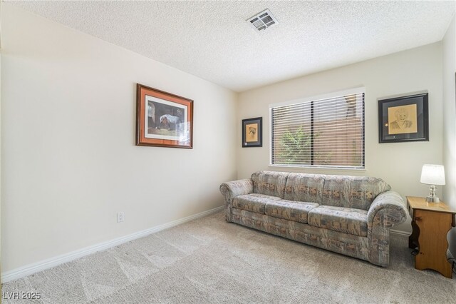 living room featuring carpet floors, a textured ceiling, and baseboards