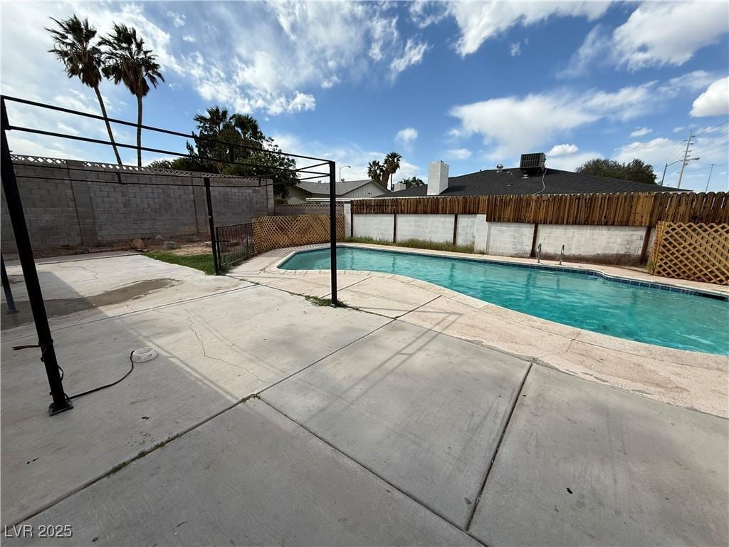 view of swimming pool featuring a fenced in pool, a patio, and a fenced backyard
