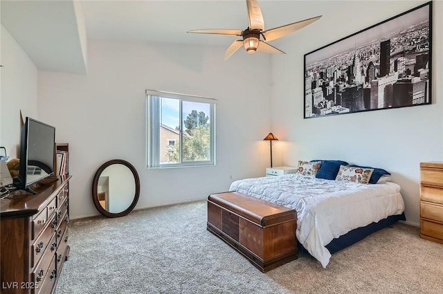 bedroom featuring lofted ceiling, a ceiling fan, and carpet flooring