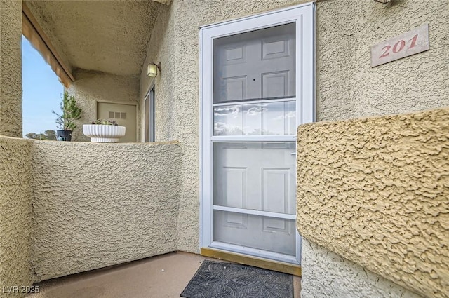 doorway to property with stucco siding