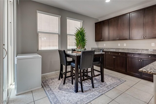 dining area featuring baseboards, recessed lighting, and light tile patterned floors