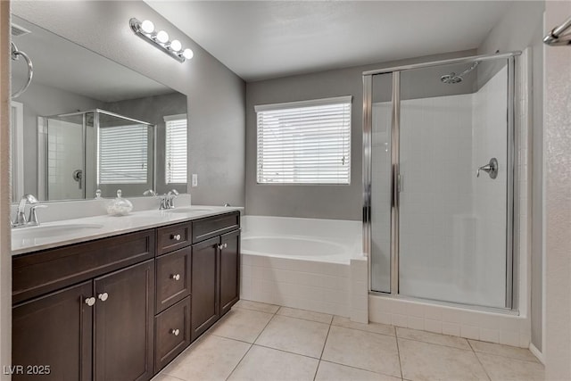 full bath with tile patterned flooring, a sink, and a shower stall