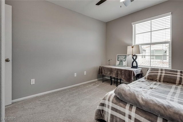 carpeted bedroom with a ceiling fan and baseboards
