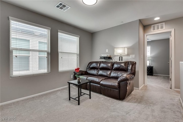 carpeted living room with baseboards and visible vents