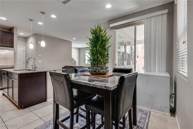 dining room with plenty of natural light, baseboards, and recessed lighting