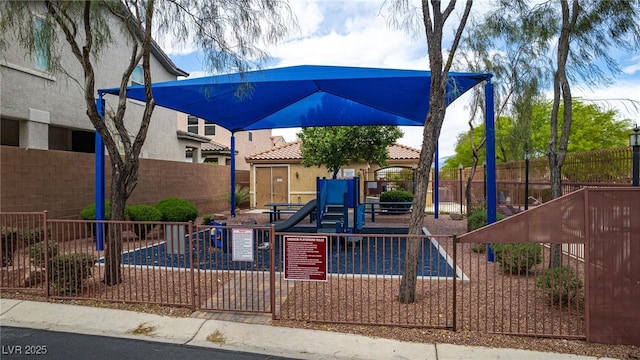 exterior space with stucco siding, fence, playground community, and a tiled roof