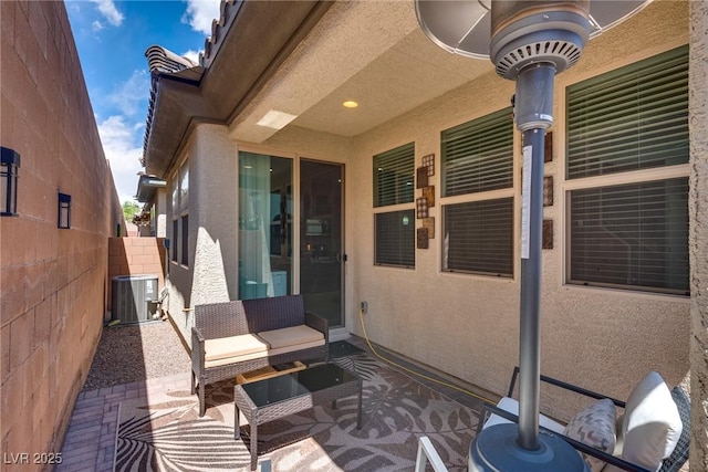 view of patio / terrace with central AC unit and fence