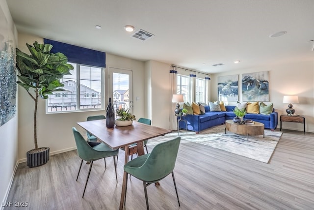 dining room with baseboards, wood finished floors, visible vents, and recessed lighting