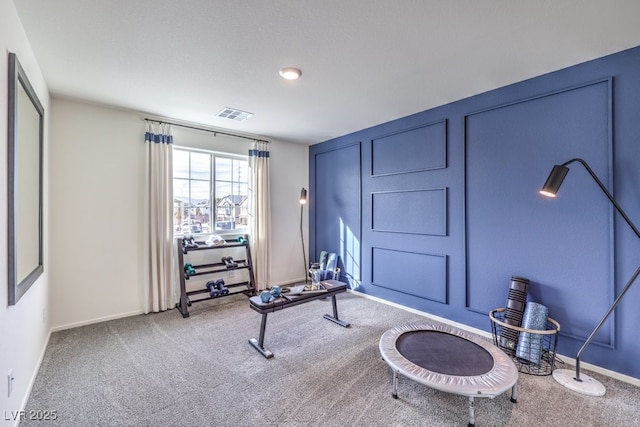 interior space featuring carpet floors, visible vents, and baseboards