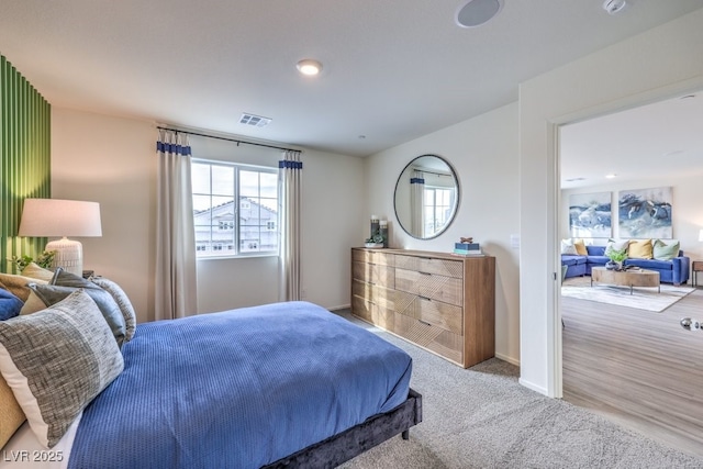 carpeted bedroom featuring visible vents and baseboards
