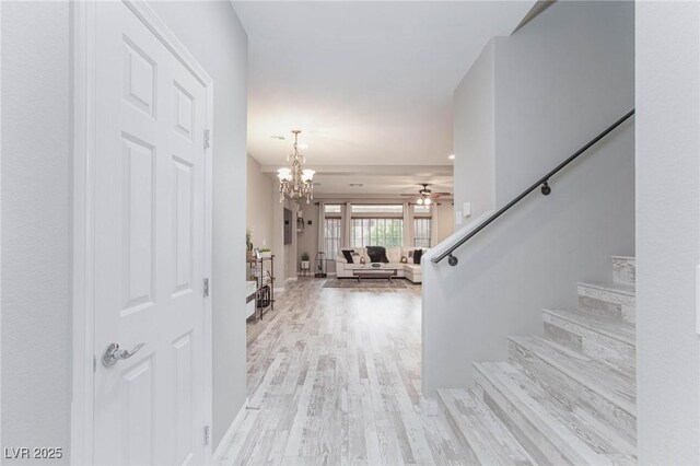 5409 Holding Ave, Las Vegas, NV 89139 - interior space featuring ceiling fan with notable chandelier, stairs, and light wood-type flooring