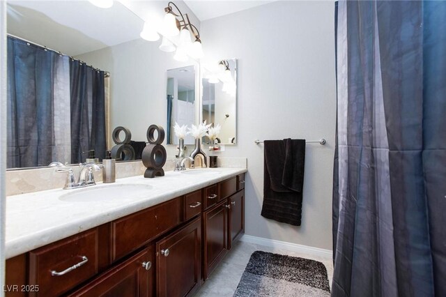 5409 Holding Ave, Las Vegas, NV 89139 - full bathroom with double vanity, tile patterned flooring, and a sink