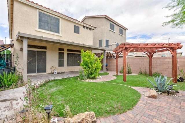 5409 Holding Ave, Las Vegas, NV 89139 - back of property featuring a pergola, a patio area, a fenced backyard, a yard, and stucco siding