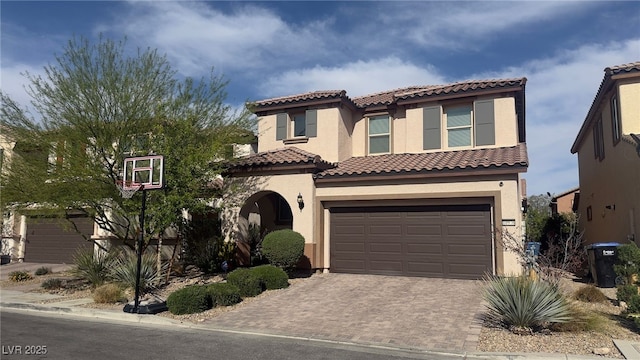 10976 Bluebell Basin Rd, Las Vegas, NV 89179 - mediterranean / spanish-style home with stucco siding, a tile roof, a garage, and decorative driveway