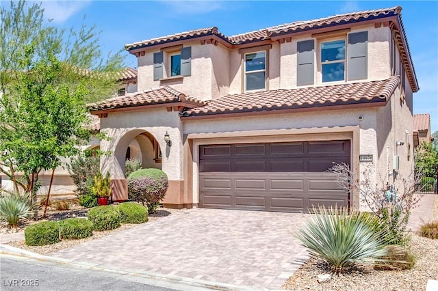 10976 Bluebell Basin Rd, Las Vegas, NV 89179 - mediterranean / spanish house featuring a tile roof, a garage, driveway, and stucco siding