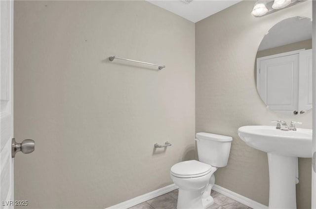 10976 Bluebell Basin Rd, Las Vegas, NV 89179 - bathroom with toilet, baseboards, a sink, and tile patterned flooring