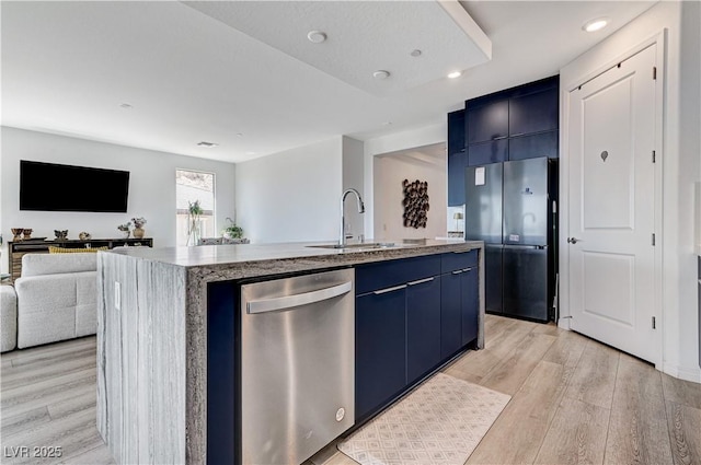 54 Mirage View Dr, Henderson, NV 89011 - kitchen with appliances with stainless steel finishes, blue cabinetry, a sink, light wood-style floors, and an island with sink