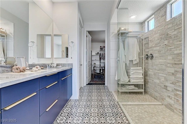 54 Mirage View Dr, Henderson, NV 89011 - bathroom featuring a walk in shower, vanity, a walk in closet, and tile patterned floors