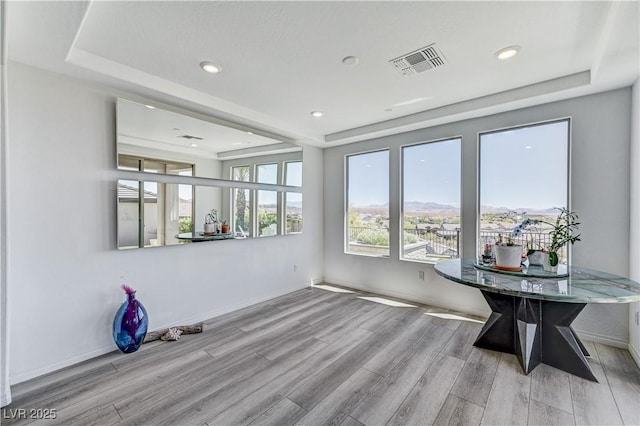54 Mirage View Dr, Henderson, NV 89011 - unfurnished dining area featuring a tray ceiling, wood finished floors, recessed lighting, and baseboards