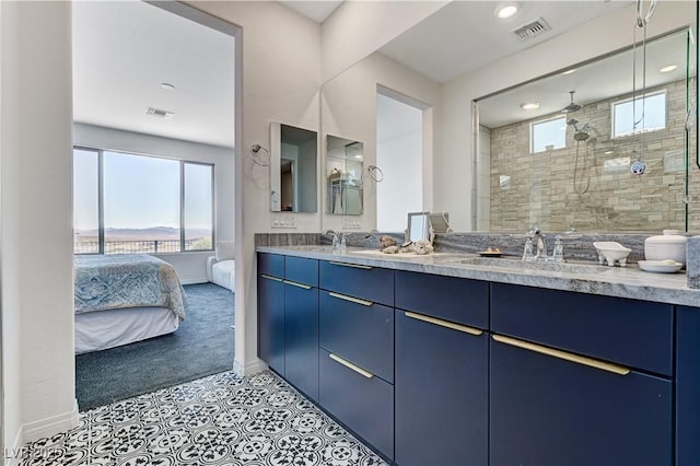 54 Mirage View Dr, Henderson, NV 89011 - bathroom featuring baseboards, a tile shower, double vanity, ensuite bath, and recessed lighting