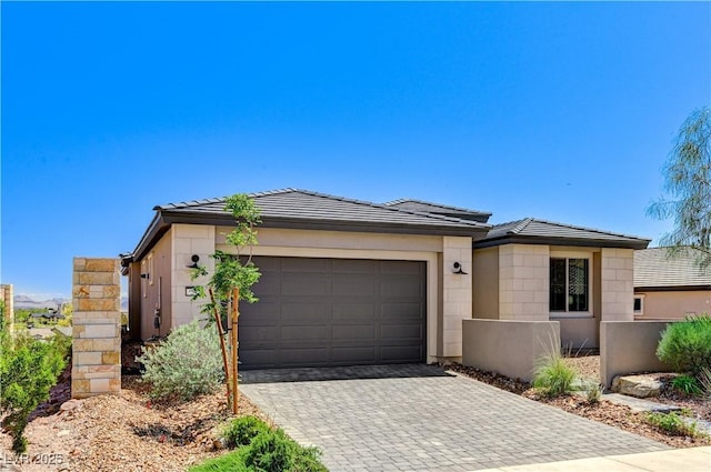 54 Mirage View Dr, Henderson, NV 89011 - view of front of house featuring decorative driveway, an attached garage, and a tile roof