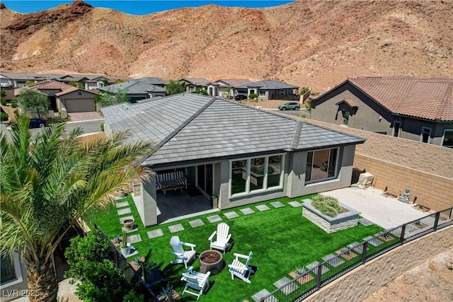 54 Mirage View Dr, Henderson, NV 89011 - back of property featuring an outdoor fire pit, a patio area, a mountain view, stucco siding, and a residential view
