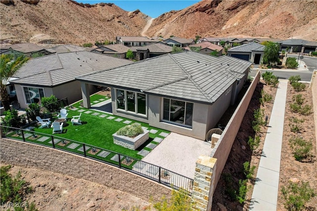 54 Mirage View Dr, Henderson, NV 89011 - rear view of house featuring a patio, stucco siding, a mountain view, and an outdoor fire pit