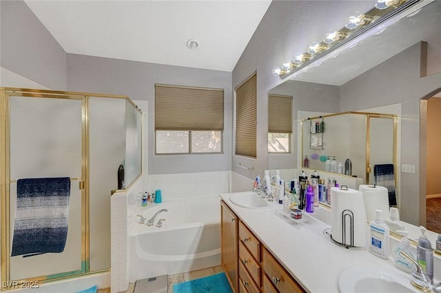 full bath with a bath, a sink, double vanity, and a stall shower
