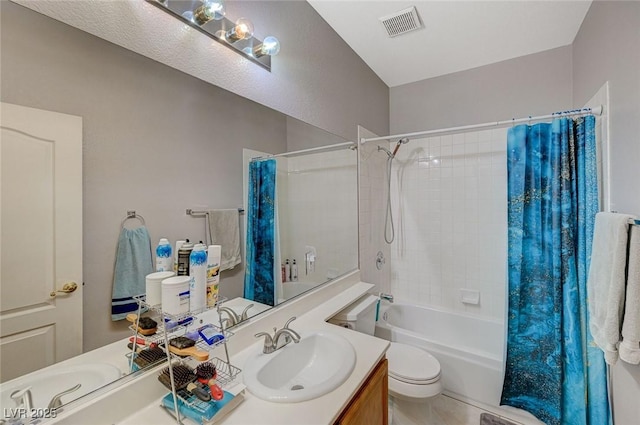 bathroom featuring toilet, vanity, shower / tub combo with curtain, and visible vents