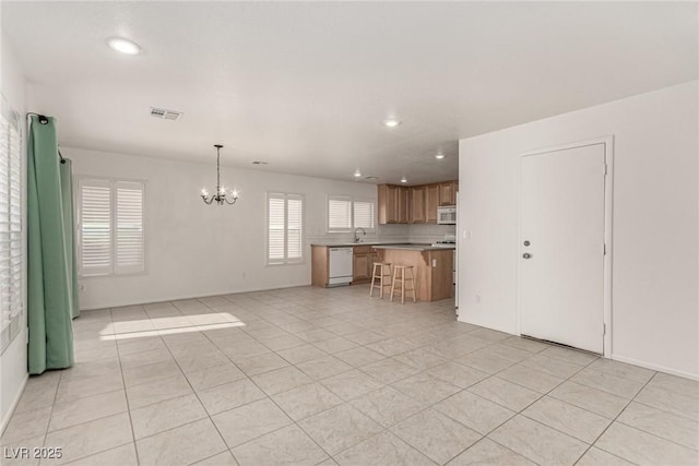 519 Brinkburn Point Ave, Las Vegas, NV 89178 - unfurnished living room featuring light tile patterned floors, a sink, visible vents, an inviting chandelier, and recessed lighting