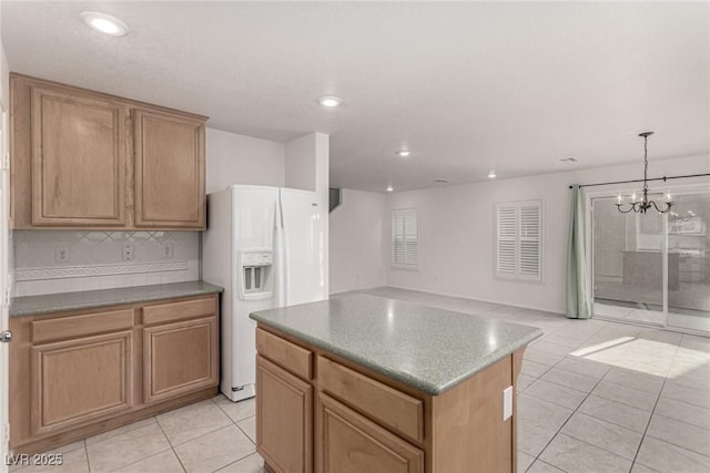 519 Brinkburn Point Ave, Las Vegas, NV 89178 - kitchen featuring a center island, tasteful backsplash, light tile patterned flooring, white fridge with ice dispenser, and an inviting chandelier